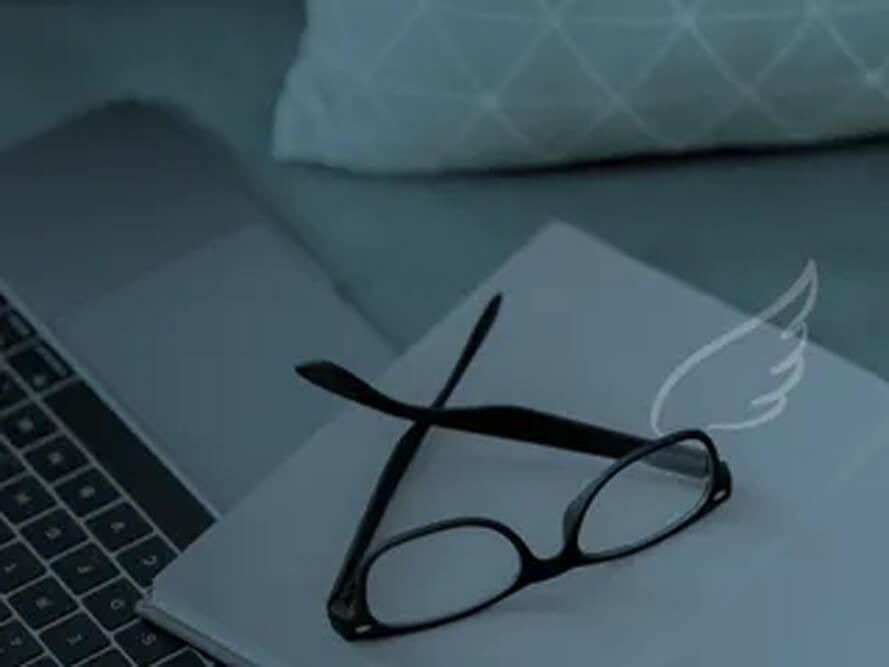 Glasses, notepad & laptop
